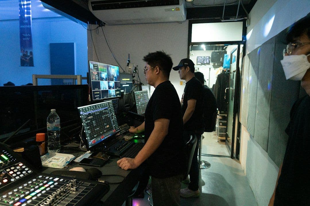 Video production desk with several monitors, illustrating a clip channel that watches multiple YouTube creators at once