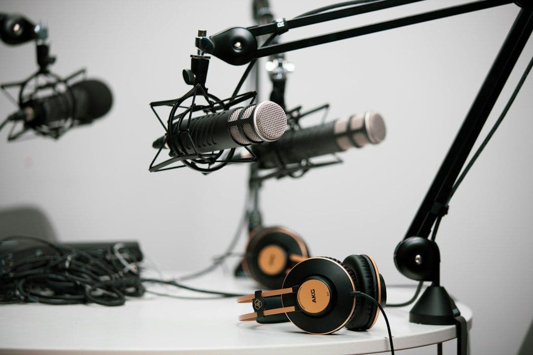 Two grey condenser microphones side by side, representing a two-speaker podcast being turned into YouTube Shorts